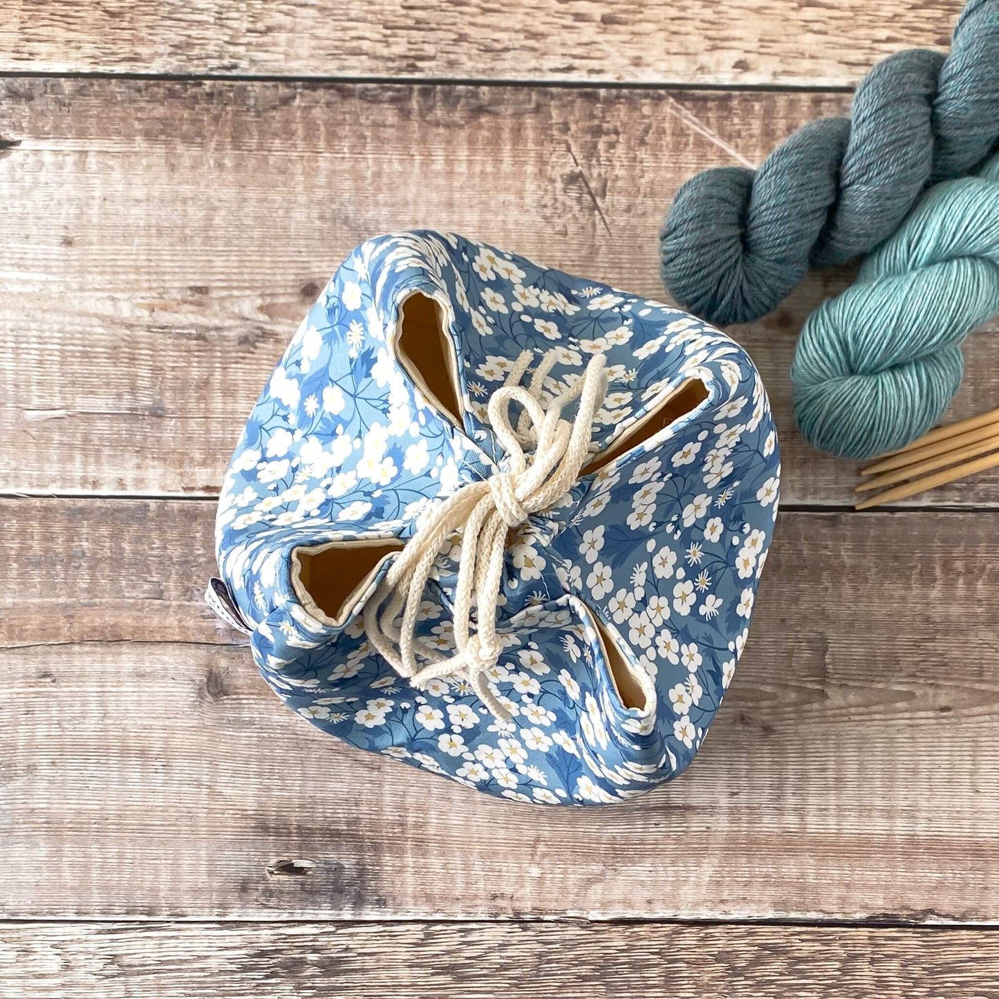 A top down view of a closed Japanese rice bag style project bag. The four corners of the bag are clearly visible.