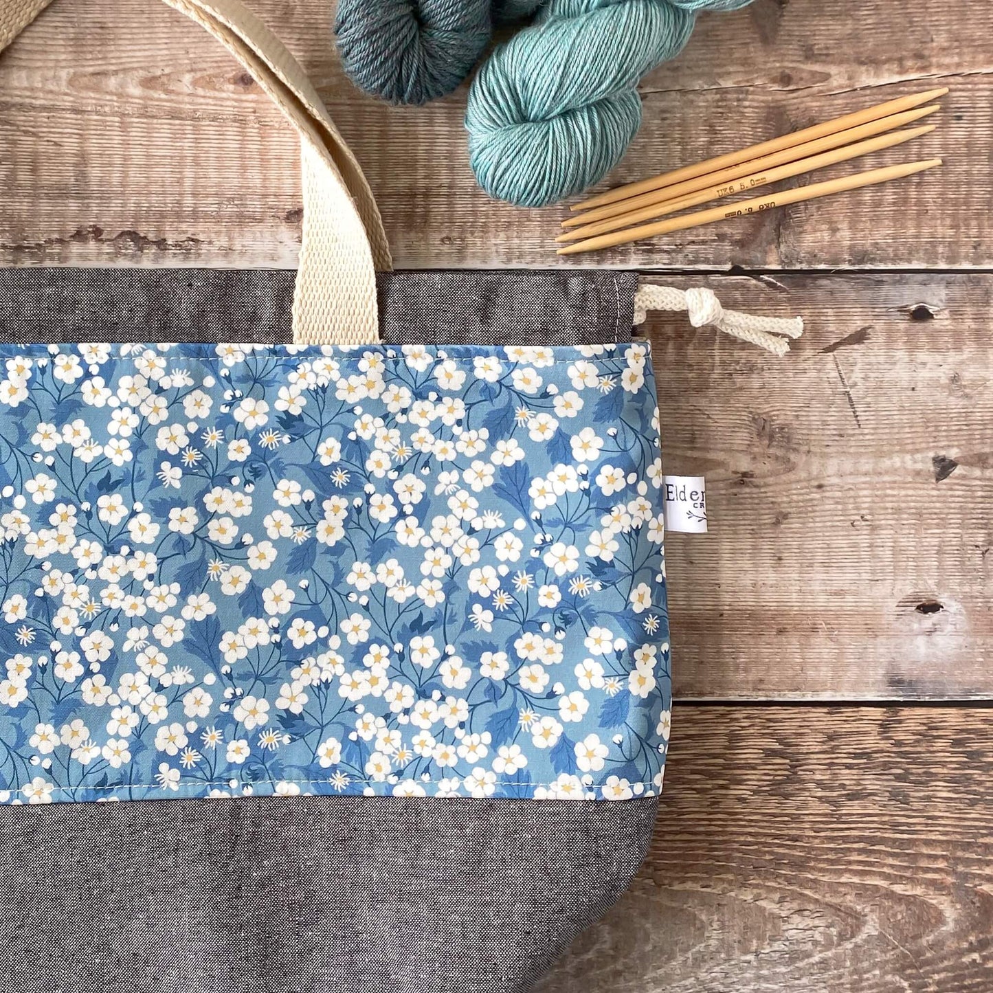 A close up flat lay of a blue floral project bag. The beautiful Liberty of London fabric is clearly seen.