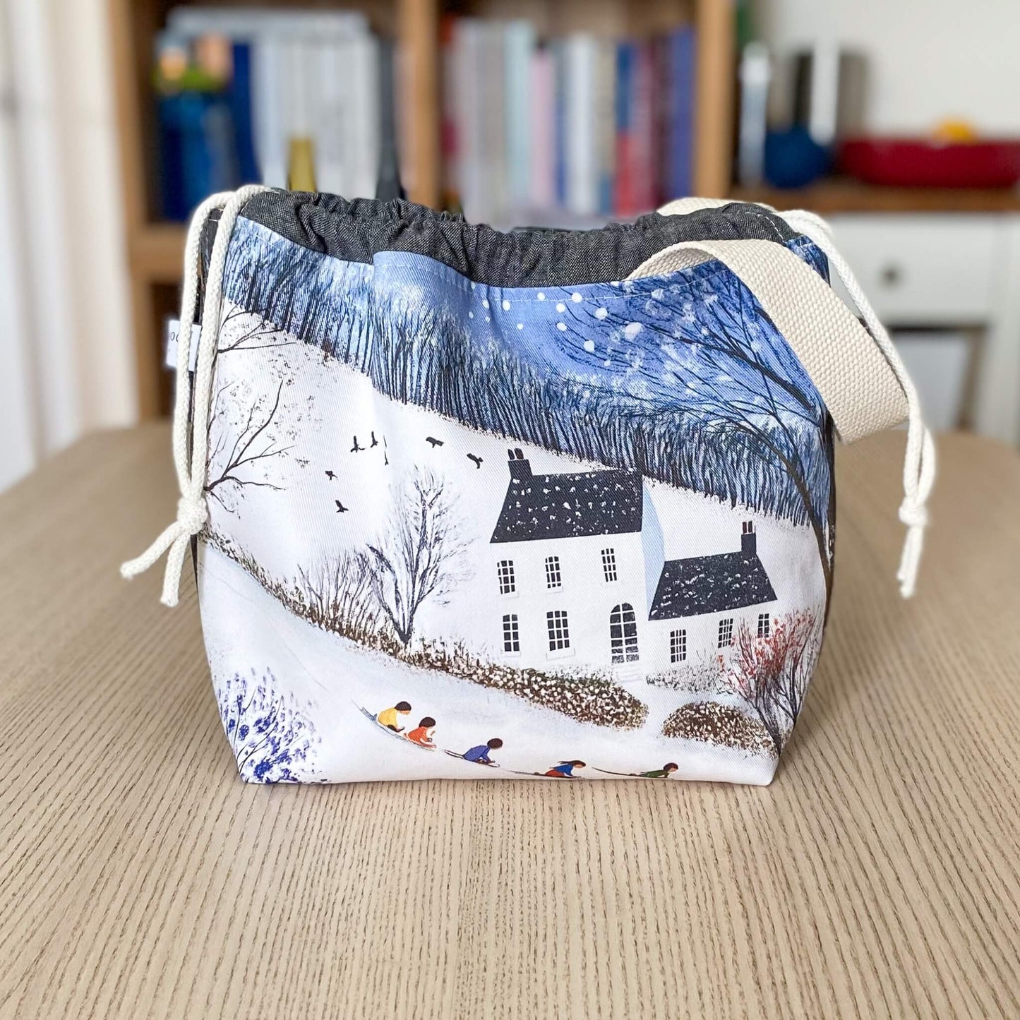 Winter craft project bag with a snowy country house scene, handmade for knitting and crochet makers