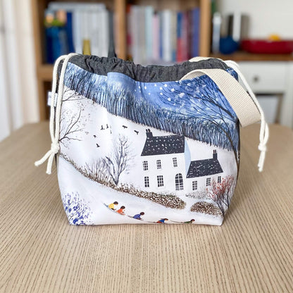 Winter craft project bag with a snowy country house scene, handmade for knitting and crochet makers