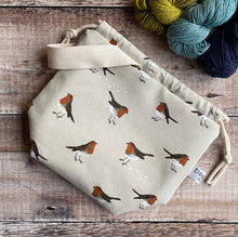 Load image into Gallery viewer, Knitting project with a drawstring closure and a winter robin print, handmade by Eldenwood Craft