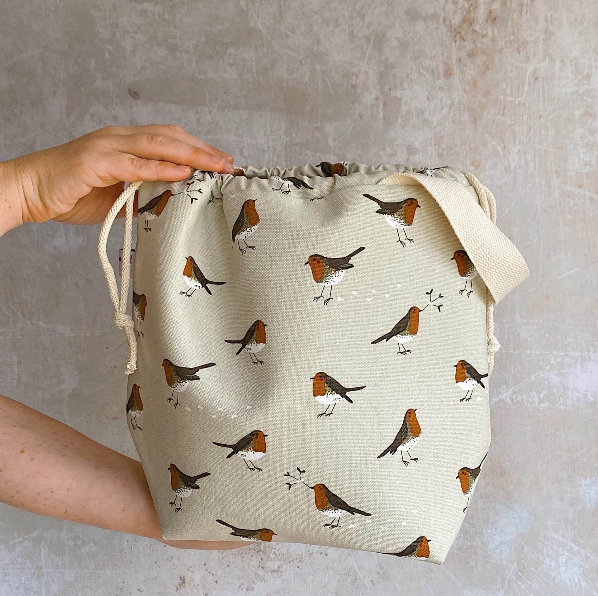 Handmade knitting project bag featuring a winter robin print, handmade by Eldenwood Craft