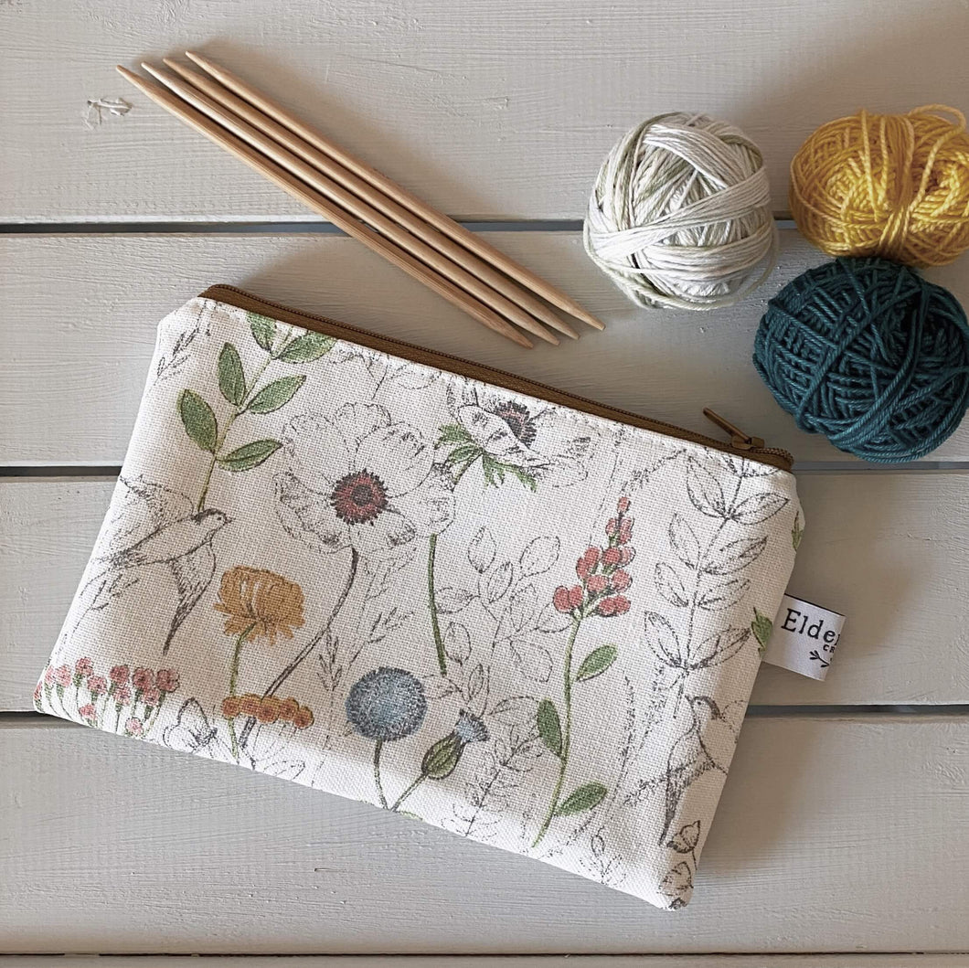 A notions pouch for knitters and crocheters, handmade by Eldenwood Craft in a summer inspired print
